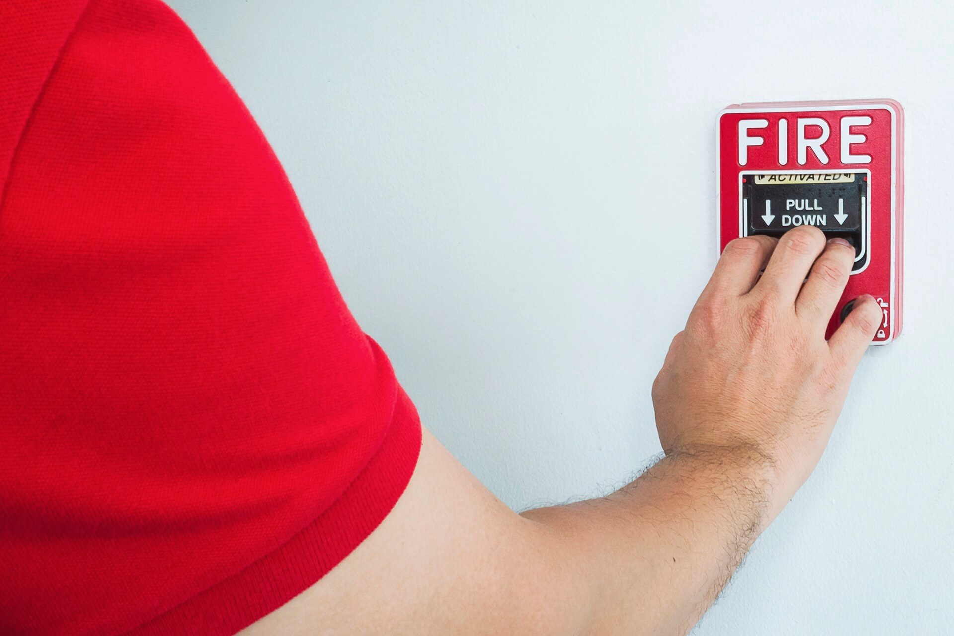 man-is-reaching-his-hand-push-fire-alarm-hand-station (1)
